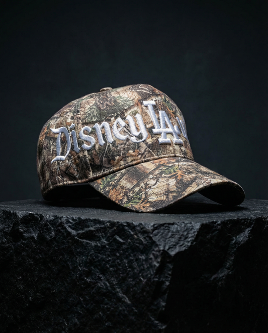 Camouflage baseball cap with 'Disney LA' text on a dark surface